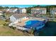 Community pool area with ample seating and lush landscaping, ideal for relaxation and recreation at 5822 Longwood Dr. # 104, Murrells Inlet, SC 29576