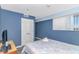 A bedroom with blue walls featuring closet and window with blind coverings at 5905 S Kings Hwy. # 1816 Rt, Myrtle Beach, SC 29575