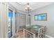 Dining room featuring a modern chandelier, neutral paint, dining table, and balcony access with a view at 5905 S Kings Hwy. # 1816 Rt, Myrtle Beach, SC 29575