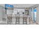 Kitchen featuring a breakfast bar, white cabinets, television, and balcony access with a beautiful view at 5905 S Kings Hwy. # 1816 Rt, Myrtle Beach, SC 29575