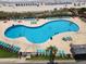 Large community pool featuring a unique shape, ample seating, and clear blue water at 5905 S Kings Hwy. # 1816 Rt, Myrtle Beach, SC 29575
