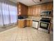 Bright kitchen with stainless appliances, oak cabinets, tile backsplash, and tile flooring at 600 65Th Ave. N # 8, Myrtle Beach, SC 29572