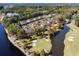 Aerial view of the condo building near a golf course, a lake, trees, and other homes in the community at 703 Riverwalk Dr. # 303, Myrtle Beach, SC 29579