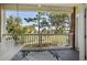 Inviting balcony features a porch swing, overlooking a serene pond and lush greenery, a perfect relaxation spot at 703 Riverwalk Dr. # 303, Myrtle Beach, SC 29579
