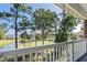 Enjoy golf course views from the balcony of this home, which also features a swing and white railing at 703 Riverwalk Dr. # 303, Myrtle Beach, SC 29579
