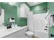 Stylish bathroom with green walls featuring modern vanity, shower-tub combo, and updated fixtures, a functional design at 703 Riverwalk Dr. # 303, Myrtle Beach, SC 29579