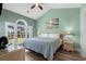 Tranquil green bedroom featuring a large window with water view, complemented by warm, inviting decor and furnishings at 703 Riverwalk Dr. # 303, Myrtle Beach, SC 29579