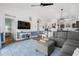 Open concept living room features vaulted ceiling, blue accent, contemporary furniture and decor, flowing into kitchen at 703 Riverwalk Dr. # 303, Myrtle Beach, SC 29579