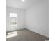 Bright bedroom with carpet and white walls, filled with natural light from a large window at 8204 S Highway 905, Longs, SC 29568