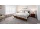 Serene bedroom featuring a queen-size bed with neutral linens and minimalist decor for a relaxing atmosphere at 8204 S Highway 905, Longs, SC 29568