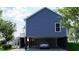 Side view of elevated home showing carport with car and stairway entrance at 8204 S Highway 905, Longs, SC 29568