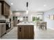 Well-designed kitchen and dining area, featuring an island, stainless steel appliances, and a light-filled dining space at 8204 S Highway 905, Longs, SC 29568