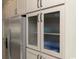 Kitchen featuring stainless steel refrigerator and pantry with reeded glass front doors at 8204 S Highway 905, Longs, SC 29568