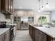 Modern kitchen featuring stainless steel appliances, a large island, and a window for natural light at 8204 S Highway 905, Longs, SC 29568