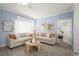 Bright living room with neutral decor featuring plush sofas, accent pillows, and a unique wicker table at 8204 S Highway 905, Longs, SC 29568