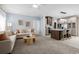 Open concept living space showcasing a spacious living room and a modern kitchen with island seating at 8204 S Highway 905, Longs, SC 29568
