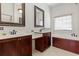 Spacious bathroom with double sinks, dark wood cabinets, and a separate soaking tub at 853 Bluffview Dr., Myrtle Beach, SC 29579