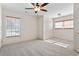 Neutral bedroom with plush carpet, two windows, and modern ceiling fan at 853 Bluffview Dr., Myrtle Beach, SC 29579