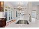 The modern kitchen island features white marble countertop and stainless steel sink at 853 Bluffview Dr., Myrtle Beach, SC 29579