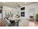Cozy living room with hardwood floors, fireplace, ceiling fan, and comfortable seating at 853 Bluffview Dr., Myrtle Beach, SC 29579