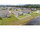 Expansive aerial view showcases the property's large, fenced yard, charming outbuilding, and proximity to a serene lake at 905 Sewing Bee Pl., Little River, SC 29566