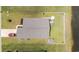 Top-down aerial view of a well-kept home with a spacious yard, outbuilding, lakeside property, and a red car parked at 905 Sewing Bee Pl., Little River, SC 29566