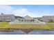View of the home's backyard with a white picket fence and access to a serene pond at 905 Sewing Bee Pl., Little River, SC 29566