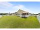 Inviting backyard featuring a well-maintained lawn, screened porch, and white picket fence, perfect for outdoor enjoyment at 905 Sewing Bee Pl., Little River, SC 29566