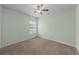 Clean bedroom featuring neutral-colored walls and carpet, ceiling fan, and window at 905 Sewing Bee Pl., Little River, SC 29566