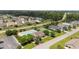 Aerial view featuring a beautiful community pool, tennis courts, clubhouse, and lush landscaping in a serene setting at 905 Sewing Bee Pl., Little River, SC 29566