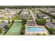 Overhead view of community amenities with a refreshing pool, well-kept tennis courts, and meticulously landscaped surroundings at 905 Sewing Bee Pl., Little River, SC 29566