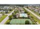 Beautiful aerial view showcasing community amenities with a pool, tennis courts, landscaped grounds, and clubhouse at 905 Sewing Bee Pl., Little River, SC 29566