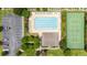 Aerial view of a refreshing community pool and tennis courts, set amidst mature trees and ample parking at 905 Sewing Bee Pl., Little River, SC 29566