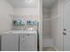 This laundry room features a washer, dryer, and shelving for storage at 905 Sewing Bee Pl., Little River, SC 29566