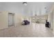Spacious living room with tile floors, ceiling fan and bright natural light from windows at 905 Sewing Bee Pl., Little River, SC 29566