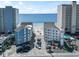 Aerial shot of condo buildings with ocean view, pool, and parking featuring proximity to the beach at 920 N Waccamaw Dr. # 1302, Garden City Beach, SC 29576