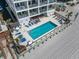 Aerial view of a condo building, pool, and beach access point at 920 N Waccamaw Dr. # 1302, Garden City Beach, SC 29576