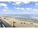 Stunning aerial view of the sandy beach with beachgoers enjoying the weather at 920 N Waccamaw Dr. # 1302, Garden City Beach, SC 29576