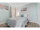 Bright bedroom featuring aqua walls, beach-themed decor, and a comfortable bed with patterned bedding at 920 N Waccamaw Dr. # 1302, Garden City Beach, SC 29576