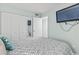 Bedroom with serene aqua walls, closet with mirror, and a comfy bed with gray and white patterned bedding at 920 N Waccamaw Dr. # 1302, Garden City Beach, SC 29576