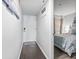Hallway with wood floor with view to bedroom featuring whitewashed walls, welcome sign, and interior door at 920 N Waccamaw Dr. # 1302, Garden City Beach, SC 29576