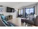 Bright living room with large TV, futon and sliding glass doors to balcony overlooking the ocean at 920 N Waccamaw Dr. # 1302, Garden City Beach, SC 29576