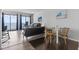 Open living space with a dining table and chairs and access to the ocean-facing balcony at 920 N Waccamaw Dr. # 1302, Garden City Beach, SC 29576