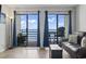 Relaxing living room with ocean view, floor lamp, sliding glass doors to balcony with comfortable seating at 920 N Waccamaw Dr. # 1302, Garden City Beach, SC 29576