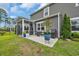 Cozy back patio featuring a seating area, grill, and vibrant potted plants for outdoor relaxation and entertainment at 933 Wild Leaf Loop, Conway, SC 29526