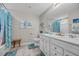 Bright bathroom with double vanity, tiled floors and coastal decor at 933 Wild Leaf Loop, Conway, SC 29526