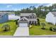 Beautiful two-story home featuring a two-car garage, landscaping, and lake views at 933 Wild Leaf Loop, Conway, SC 29526