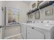 Functional laundry room equipped with a washer, dryer, and shelving for organized storage and convenience at 933 Wild Leaf Loop, Conway, SC 29526