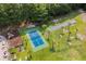 Aerial view showcasing a basketball court, shuffleboard, and playground surrounded by dense Carolina trees and lush grass at 1009 Hopscotch Ln., Conway, SC 29526