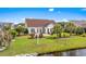 Beautiful backyard with a patio, landscaping, canal view, and manicured lawn at 1009 Hopscotch Ln., Conway, SC 29526